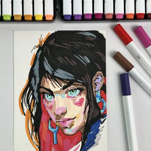 Portrait drawing beside markers
